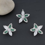 Emerald green and white crystal floral stud earrings with sparkling stones in a silver finish luxury jewellery design.

