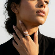Rose gold geometric pyramid ring with sparkling crystal pave detailing on a modern luxury statement band for women.
