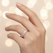 Rose gold eternity ring with princess cut crystals and pavé detailing for women’s luxury jewelry styling.
