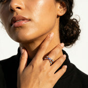Rose gold crossover evil eye ring with blue enamel accents
