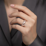 Elegant rose gold eternity ring with sparkling baguette-cut crystal stones in a luxurious modern band design.
