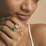 Rose gold open ring with crystal pave detailing and green striped gemstone accent in modern geometric design for women
