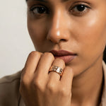 Rose gold crystal band ring with star and teardrop stone detailing on a polished luxury.
