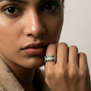 Luxury emerald baguette eternity ring with sparkling crystal accents in a polished silver-tone finish.
