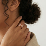 Rose gold peach crystal statement ring with pave stones and sparkling cushion-cut centrepiece
