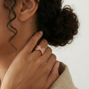 Rose gold peach crystal statement ring with pave stones and sparkling cushion-cut centrepiece
