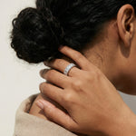 Radiant baguette eternity ring with sparkling crystal accents and modern silver-tone band design for women.
