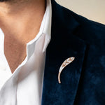 Rose gold chevron brooch pin with sparkling crystal detailing and iridescent shell inlay in a sleek curved design.
