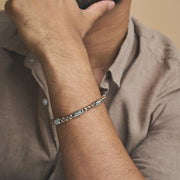 Rose gold and silver dual-tone twist link bracelet with textured accents and lobster clasp closure
