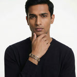 Dual tone barrel link bracelet with polished silver and gold finish featuring modern geometric links and clasp closure.
