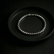 Elegant silver-tone pyramid link bracelet with geometric square bead design and polished finish
