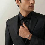 Minimalist silver-tone link bracelet with textured barrel accents and modern geometric chain design