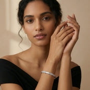 Elegant radiant baguette charm bracelet with sparkling stone detailing and sleek silver finish
