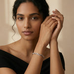 Rose gold infinity link bracelet with sparkling crystal accents and dual-tone chain design for women.
