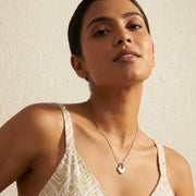 Elegant blush geometric pearl pendant necklace with rose gold finish and crystal detail on delicate chain
