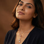 Rose gold blush heart charm necklace with dual dangling heart pendants and elegant minimalist chain design for women
