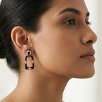Black and rose gold geometric drop earrings with sparkling stone accents and glossy enamel finish for women’s luxury fashion jewelry.

