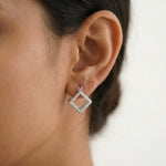 Elegant square hoop earrings with sparkling stone detailing in a modern geometric open-frame design for women.

