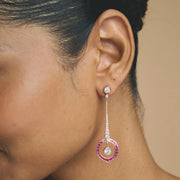 Rose gold pink halo drop earrings with sparkling white stones and circular gemstone design for women
