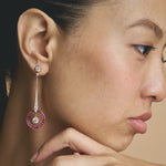 Rose gold pink halo drop earrings with sparkling white stones and circular gemstone design for women
