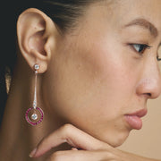 Rose gold pink halo drop earrings with sparkling white stones and circular gemstone design for women
