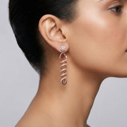 Rose gold spiral drop earrings with sparkling stone detailing and elegant twisted long dangle design for women.
