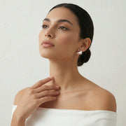 Rose gold pearl wing earrings with sparkling crystal accents and elegant modern design for women
