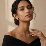 Rose gold ivory twist halo earrings with sparkling stone detailing and modern oval design for women.
