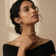 Rose gold black flower tassel earrings with sparkling stones and long dangling chain design for women.
