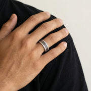 Elegant Greek pattern crystal ring with black enamel detailing and sparkling stone accents on a sleek silver-tone band.
