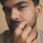 Elegant rose gold dome ring with embedded crystal accents and polished silver inner band isolated
