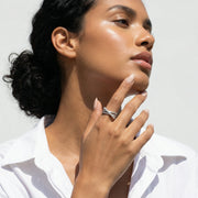 Elegant crystal cross wrap ring with overlapping pave stone design in polished silver finish for women’s fashion jewellery.
