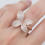 Rose gold floral crystal ring with sparkling pave petals and elegant open band design for women.
