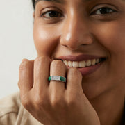 Emerald stripe crystal ring with sparkling stones and modern geometric silver band design
