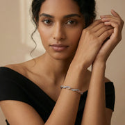 Luxury interwoven dual tone bracelet with braided rose gold and silver chain design for elegant women’s jewellery styling.
