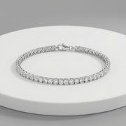 Elegant radiant crystal tennis bracelet with sparkling round stones and polished silver finish
