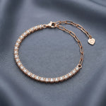 Rose gold crystal tennis bracelet with sparkling stones and adjustable chain clasp
