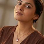 Blush rose pearl pendant necklace and matching floral stud earrings jewellery set with crystal accents in rose gold finish.
