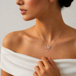 Elegant rose gold butterfly drop necklace with crystal butterfly charms and teardrop pendant design

