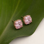 Elegant blush pink cushion crystal stud earrings with rose gold finish and sparkling square-cut stones
