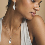 Elegant silver-tone leaf drop necklace and earrings jewelry set with sparkling crystal accents

