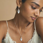 Elegant silver-tone leaf drop necklace and earrings jewellery set with sparkling crystal accents
