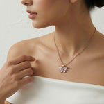 Blush butterfly crystal jewelry set with rose gold pendant necklace and matching stud earrings
