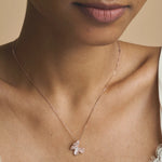 Elegant rose gold butterfly pendant necklace with matching blush pink crystal earrings displayed
