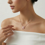 Rose gold lucky clover necklace and earrings set with blush enamel petals and sparkling crystal heart centrepiece
