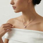 Blush rose quartz pendant necklace with matching stud earrings in rose gold finish
