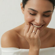 Rose gold baguette crystal band ring with polished finish and geometric stone detailing for women.
