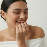 Rose gold blush crystal vine ring with large cushion-cut gemstone and elegant leaf design for women’s luxury jewelry styling.
